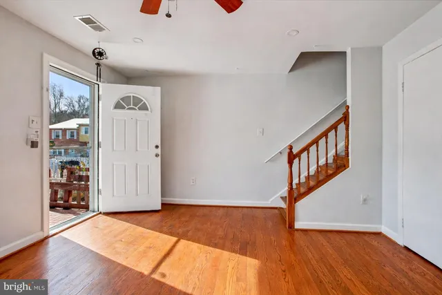 a view of an entryway with wooden floor
