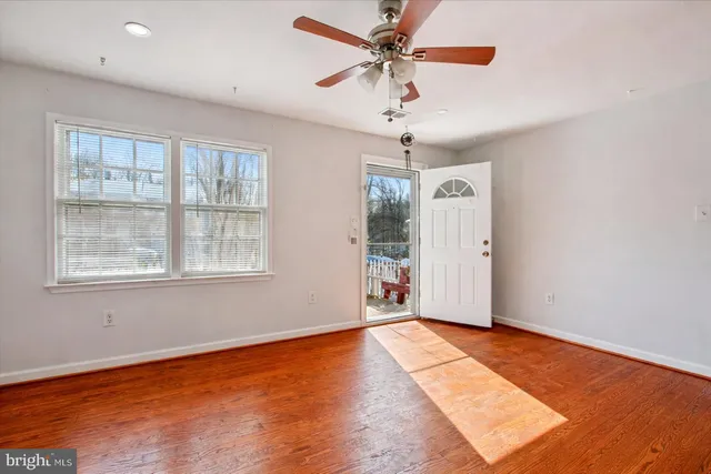 wooden floor in an empty room with a window