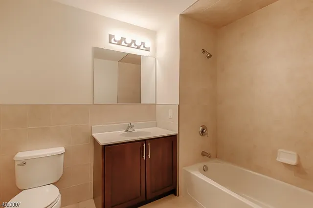 a kitchen with a refrigerator sink and cabinets