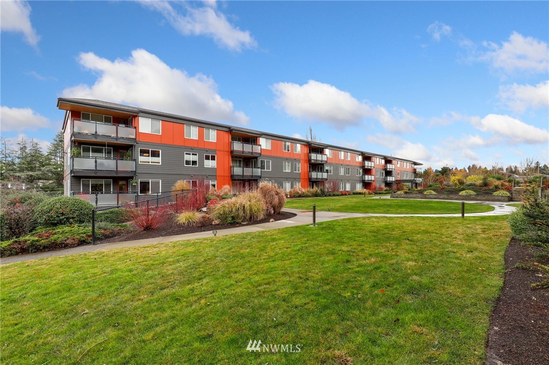 7001 Sand Point Way Northeast, Unit C309 Seattle, WA 98115 - Photo 1 of 38 a view of a house with a big yard