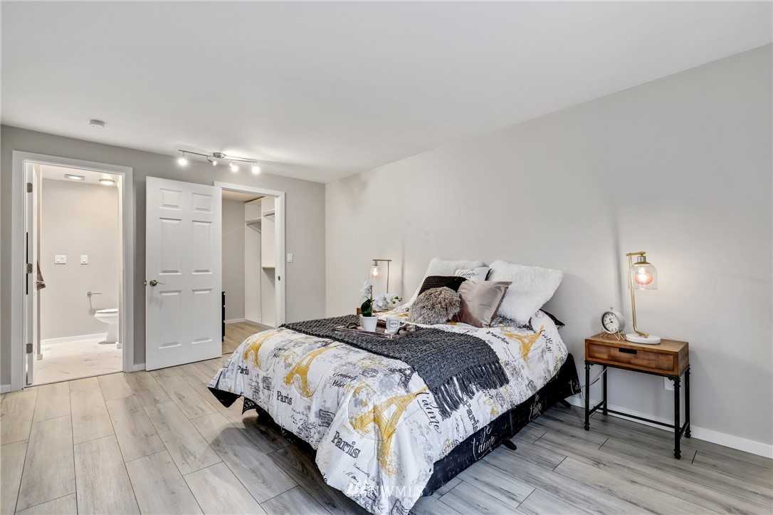 7001 Sand Point Way Northeast, Unit C309 Seattle, WA 98115 - Photo 11 of 38 a bedroom with a bed and a table