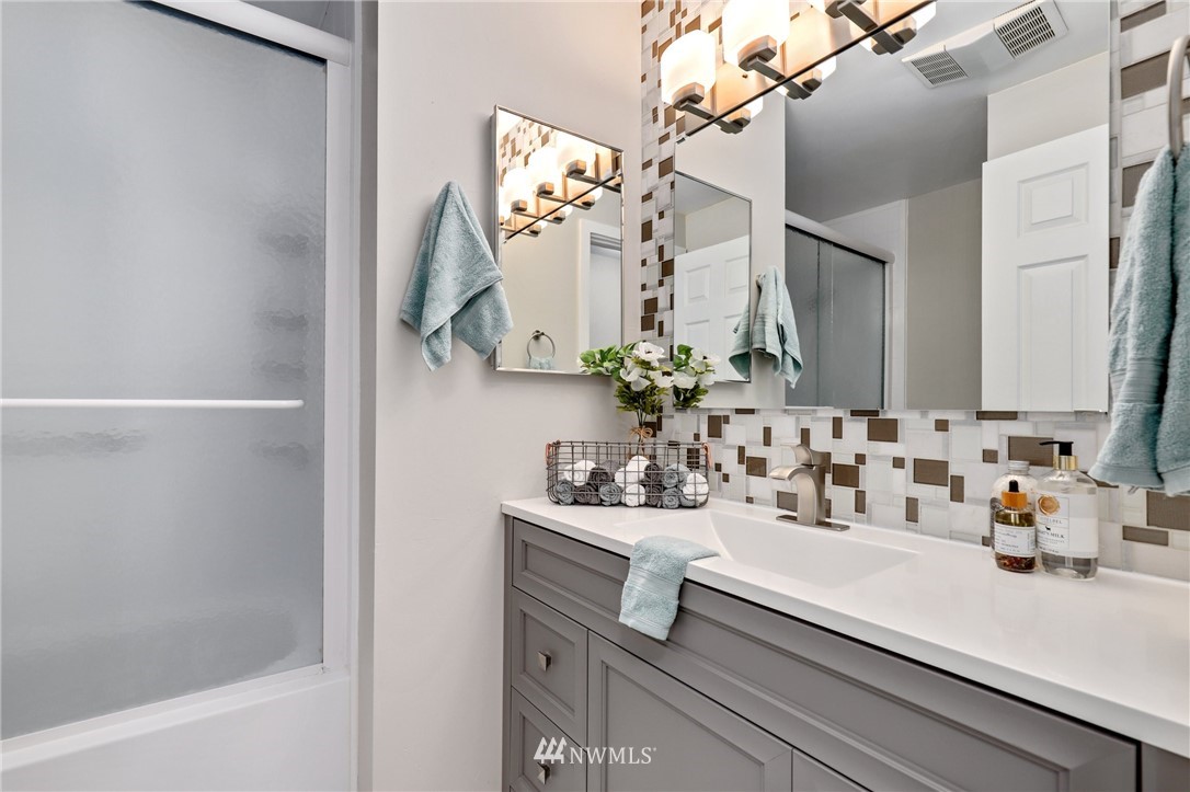 7001 Sand Point Way Northeast, Unit C309 Seattle, WA 98115 - Photo 14 of 38 a bathroom with a sink and a mirror
