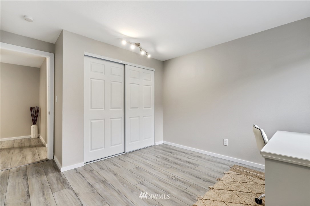 7001 Sand Point Way Northeast, Unit C309 Seattle, WA 98115 - Photo 16 of 38 a view of empty room with wooden floor