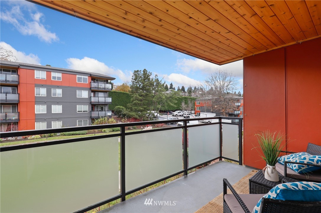 7001 Sand Point Way Northeast, Unit C309 Seattle, WA 98115 - Photo 18 of 38 a view of a balcony with chairs and potted plants
