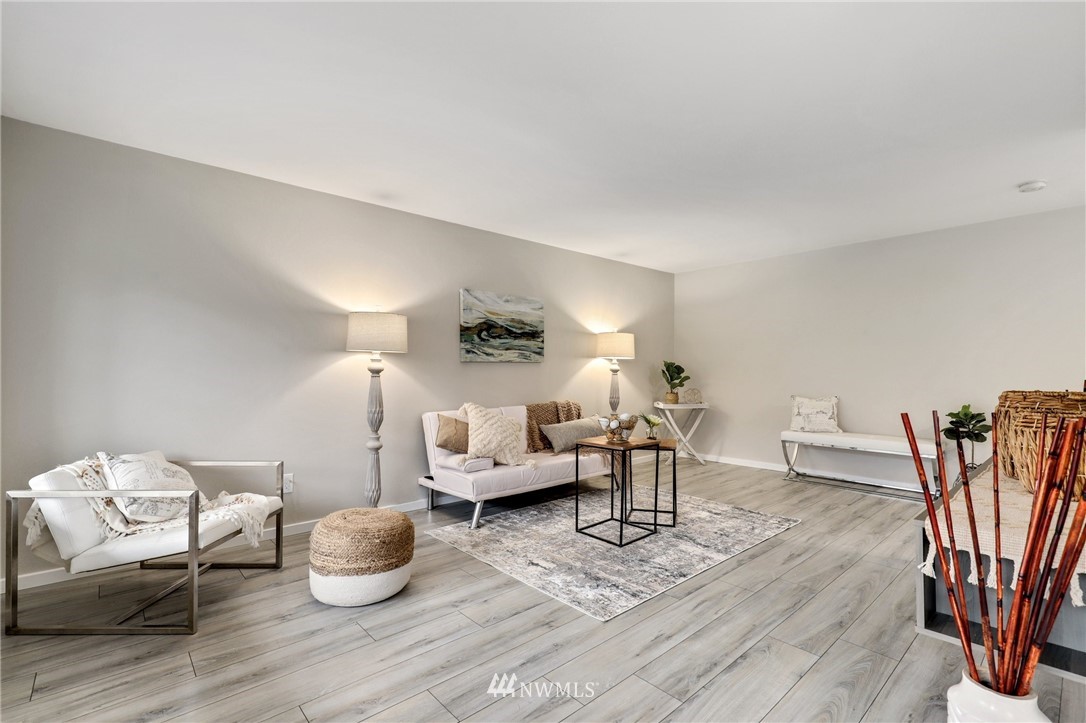 7001 Sand Point Way Northeast, Unit C309 Seattle, WA 98115 - Photo 3 of 38 a living room with furniture and a wooden floor