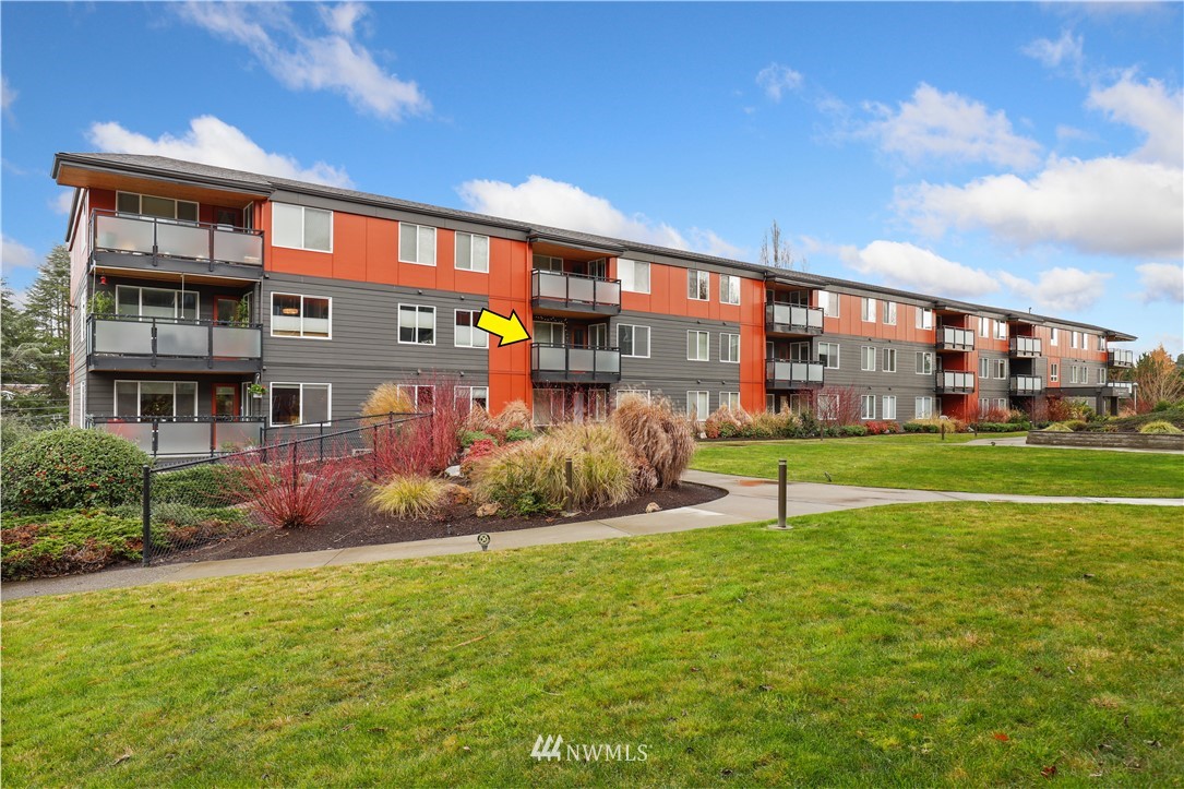 7001 Sand Point Way Northeast, Unit C309 Seattle, WA 98115 - Photo 22 of 38 a view of a building with a yard