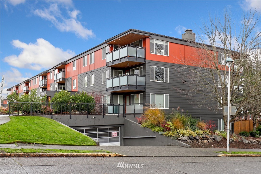 7001 Sand Point Way Northeast, Unit C309 Seattle, WA 98115 - Photo 24 of 38 a front view of a house with a yard