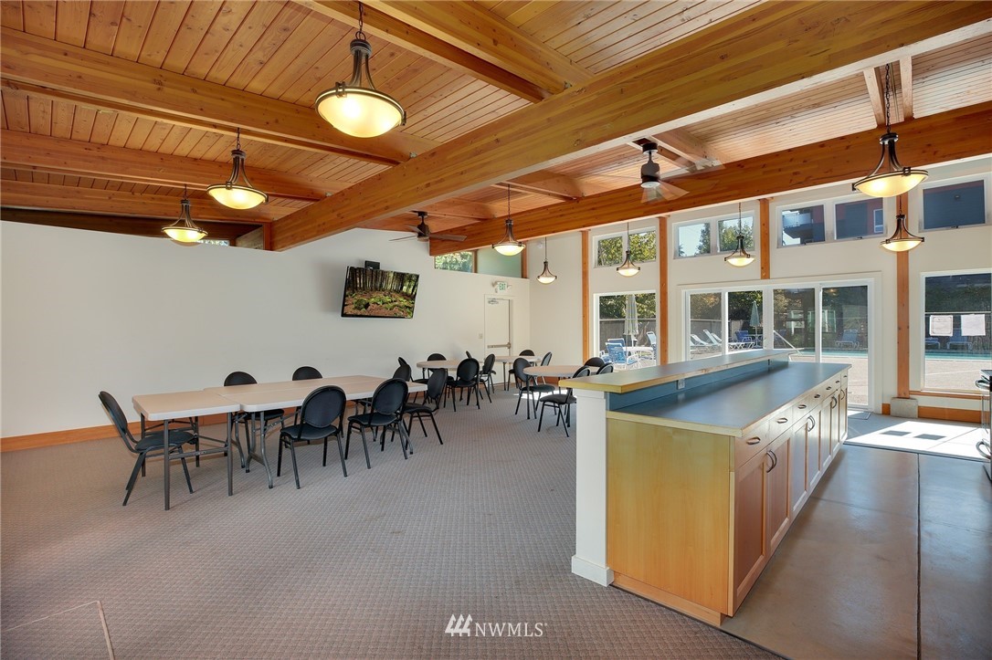 7001 Sand Point Way Northeast, Unit C309 Seattle, WA 98115 - Photo 28 of 38 a view of a dining room with furniture and chandelier