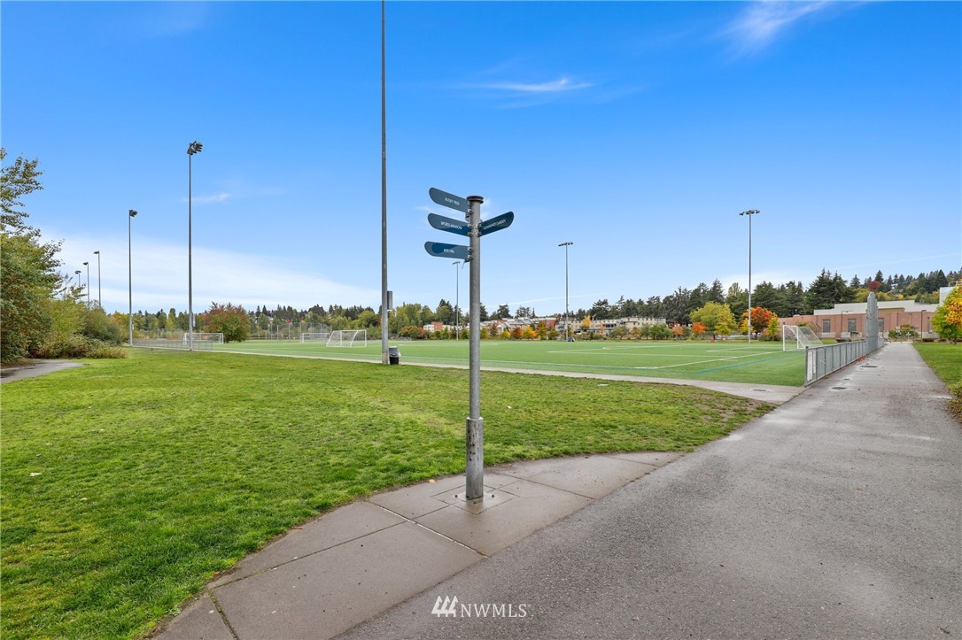7001 Sand Point Way Northeast, Unit C309 Seattle, WA 98115 - Photo 31 of 38 a view of a golf course with a lake view