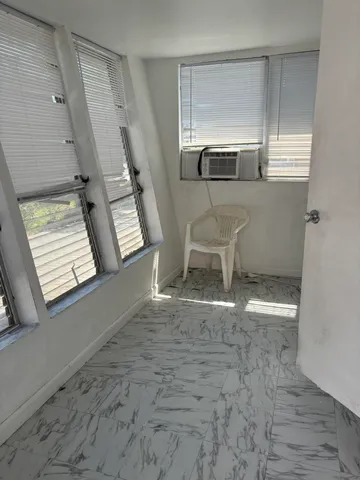 a view of an empty room with a window