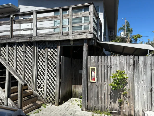 a front view of a house with wooden fence