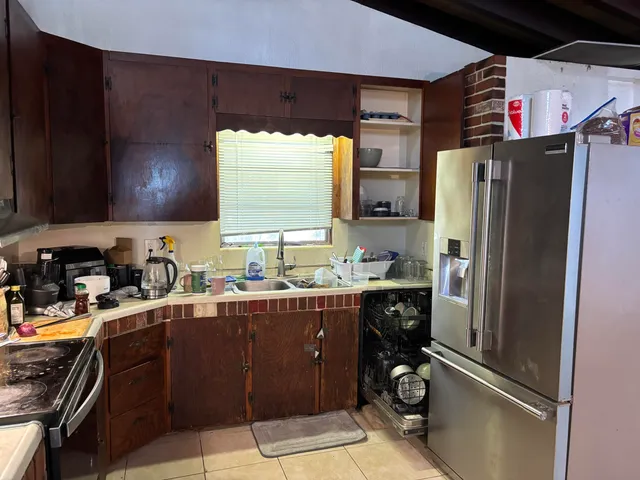 a kitchen with a refrigerator and a sink