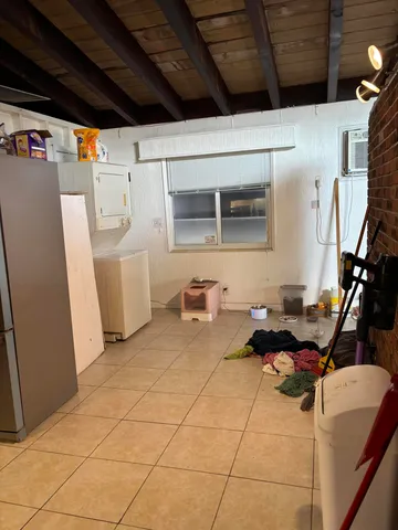 a gym room with furniture and a window