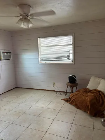 a living room with a baby crib furniture and a window