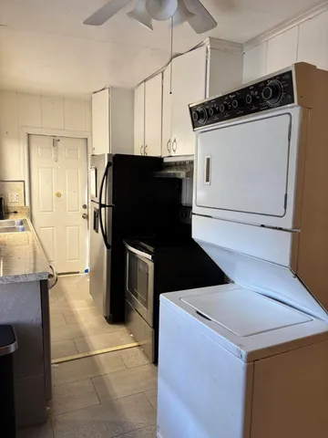 a kitchen with a refrigerator and a sink