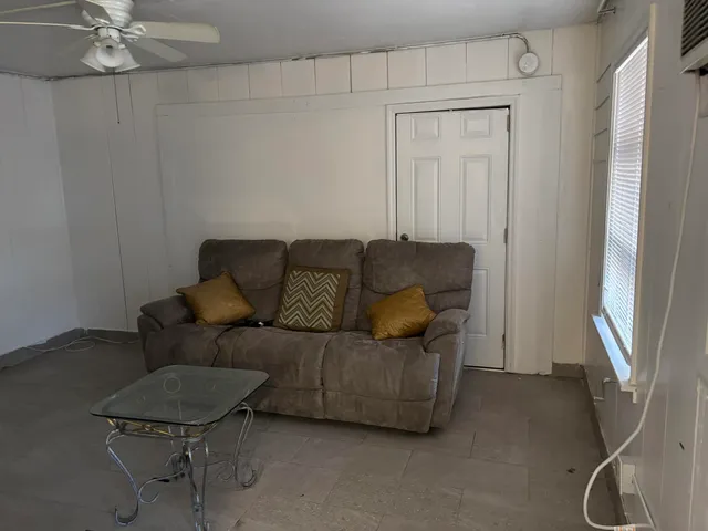 a living room with furniture and a window