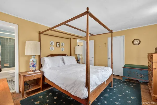 a bedroom with a bed and a dresser