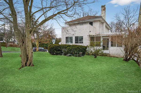 a front view of a house with a garden