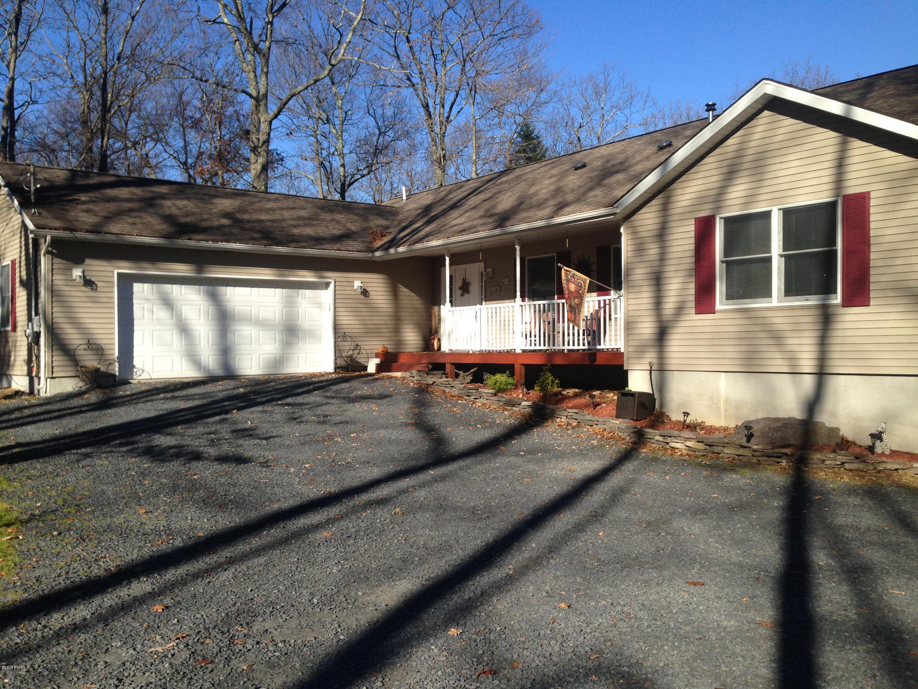 141 Weasel Road Dingmans Ferry, PA 18328 - Photo 2 of 28 a front view of a house with a yard