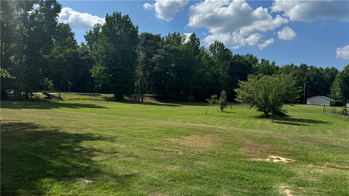 101 Due West Road Belton, SC 29627 - Photo 19 of 22 A spacious, verdant lot with a tree-lined border provides a serene setting for your future home.