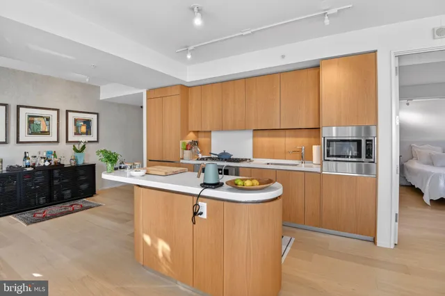 a kitchen with stainless steel appliances granite countertop a sink counter space and a large window
