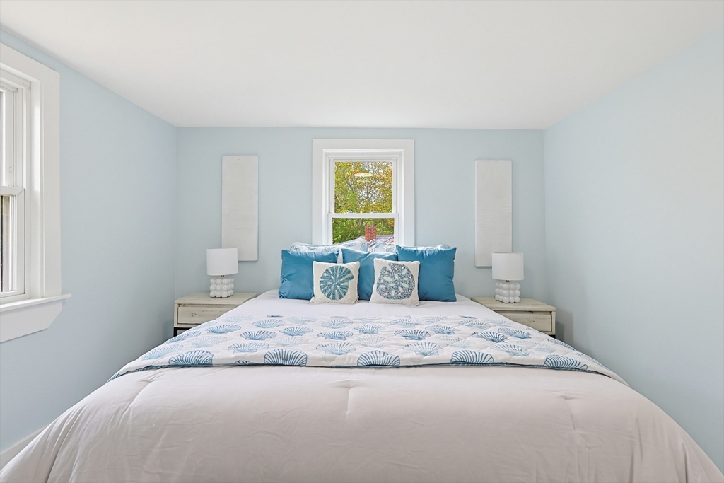 24 Otis Road Barnstable, MA 02601 - Photo 21 of 33 a bedroom with a large bed and wooden floor