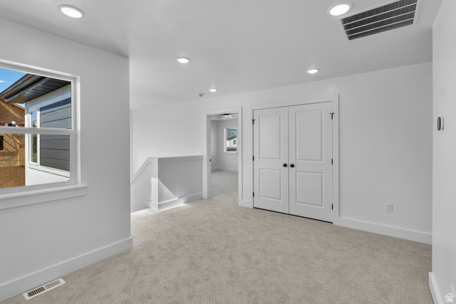 248 West 2920th Street South Logan, UT 84321 - Photo 39 of 47 Recessed ceiling lighting, light-toned carpeting, white double doors, white window trim, and white walls