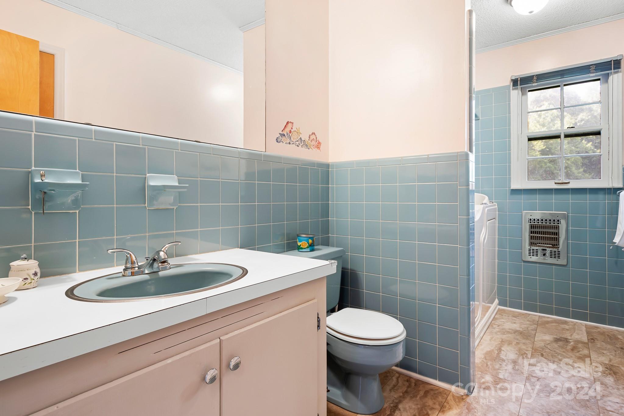 918 Blacksnake Road Stanley, NC 28164 - Photo 16 of 41 a bathroom with a sink a toilet and mirror