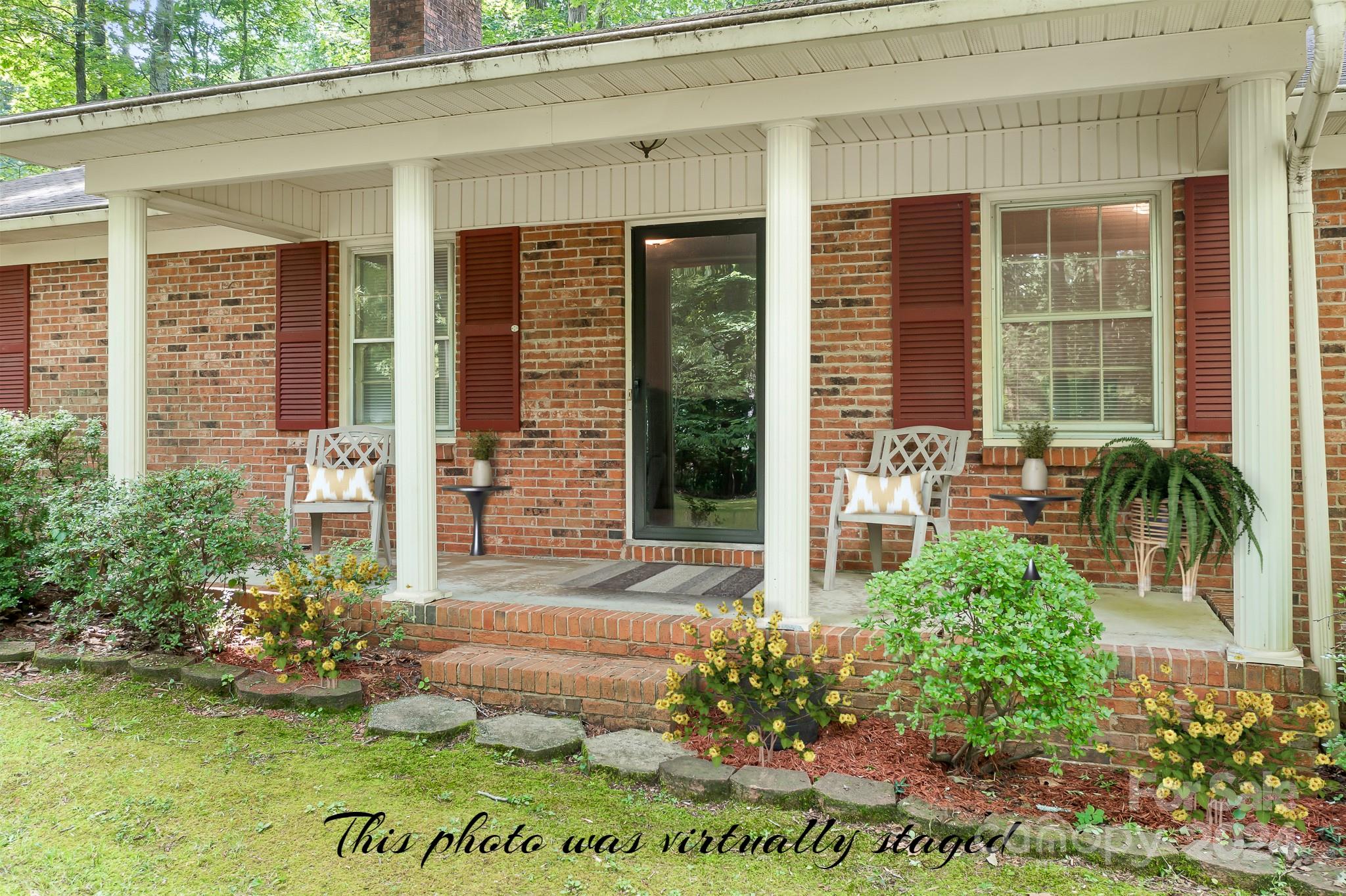 918 Blacksnake Road Stanley, NC 28164 - Photo 3 of 41 a front view of a house with garden