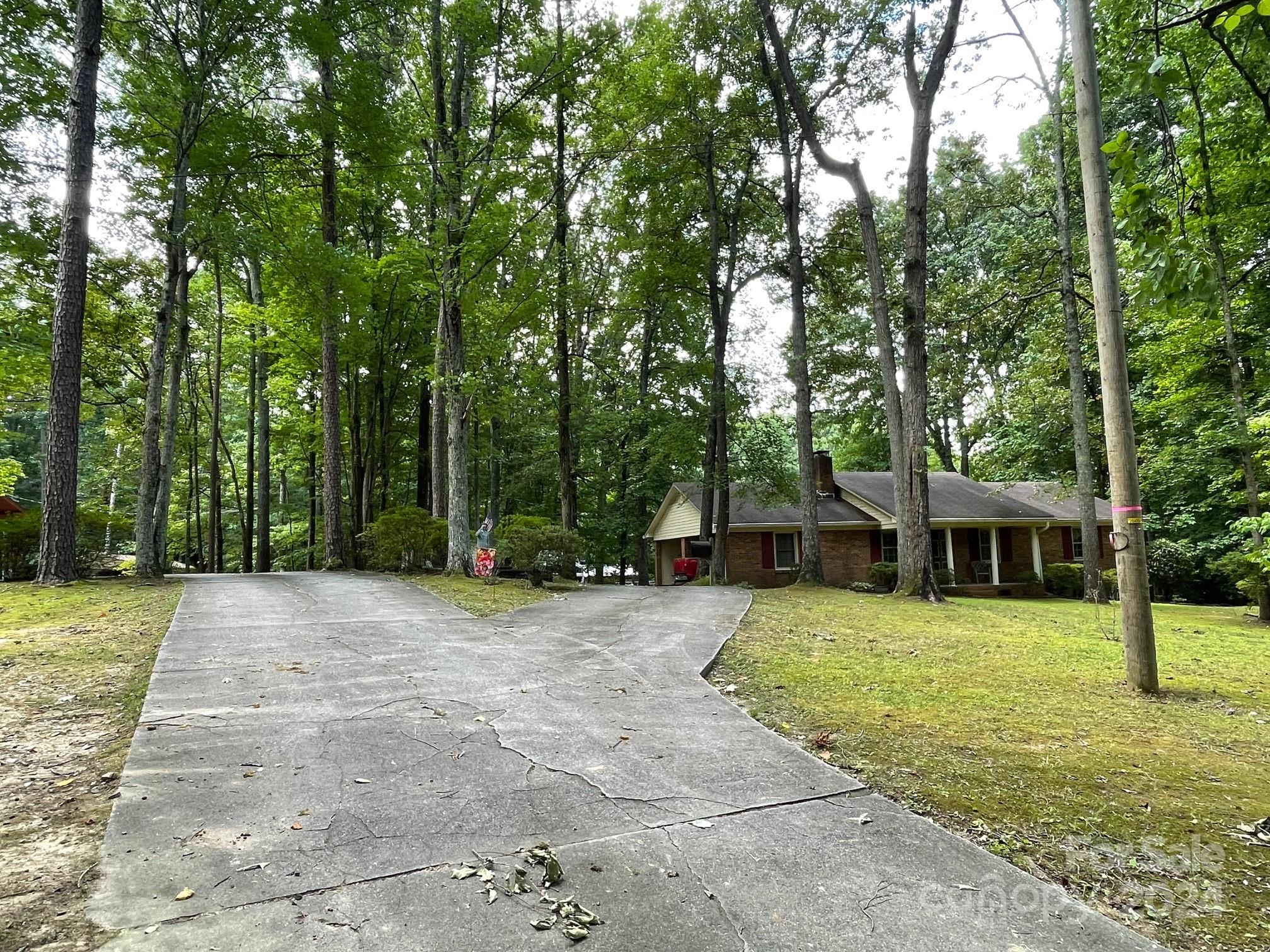 918 Blacksnake Road Stanley, NC 28164 - Photo 39 of 41 a view of a house with a big yard and large trees
