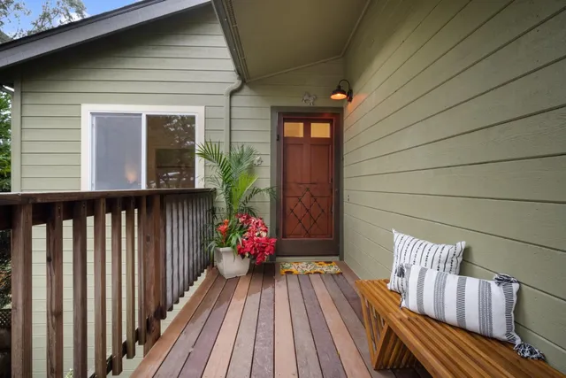 a view of balcony with wooden floor and outdoor seating