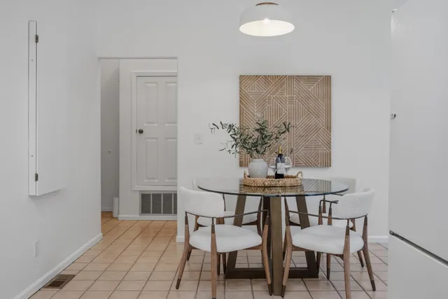 a dining room with furniture and wooden floor