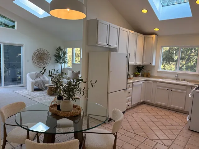 a kitchen with a sink cabinets and window