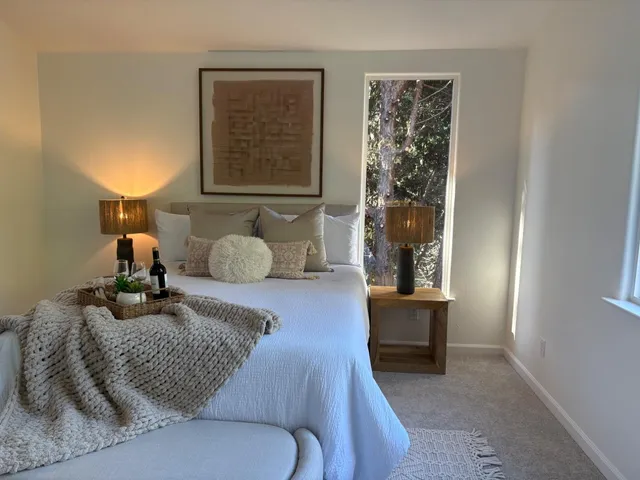 a bedroom with a bed and window