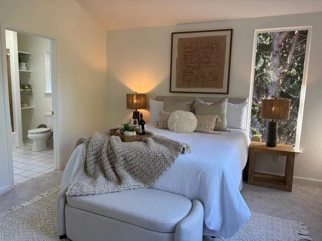 a bedroom with a bed and window