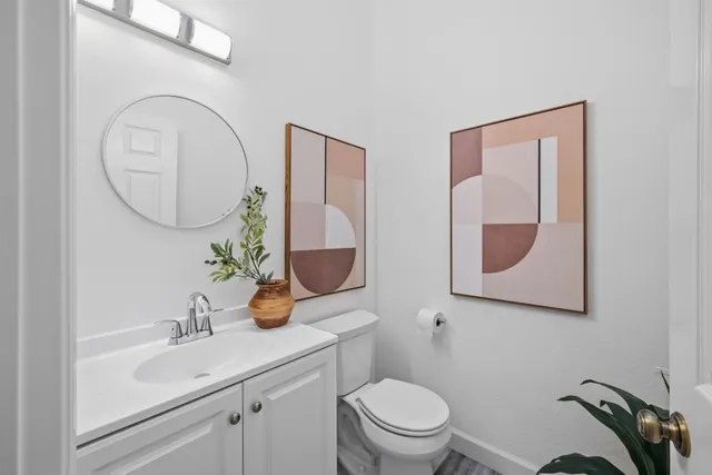 a bathroom with a toilet a sink and mirror