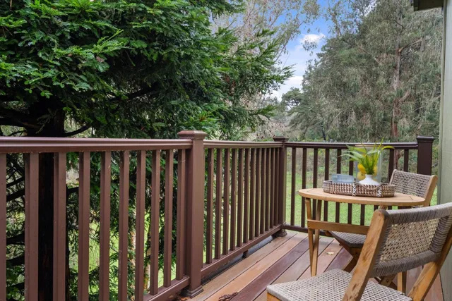 a view of a chair and table in the balcony