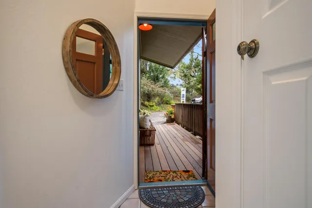 a view of a porch with a hanging floor to ceiling window and a mirror