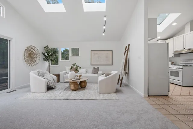 a living room with fireplace furniture and a table