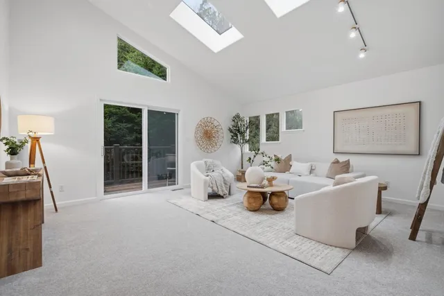 a living room with fireplace furniture and a large window