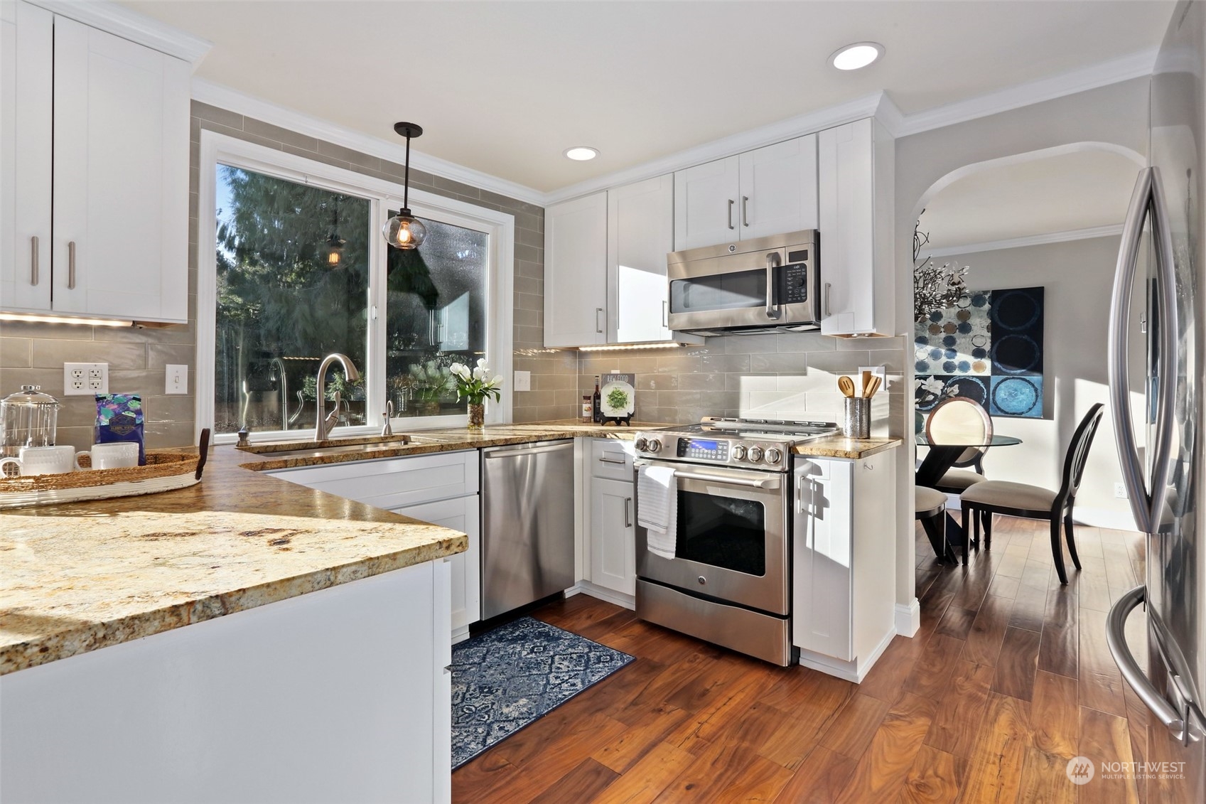 3004 170th Place Southeast Bothell, WA 98012 - Photo 5 of 25 a kitchen with stainless steel appliances granite countertop a stove a sink and a refrigerator