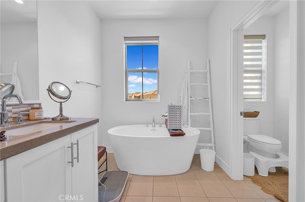 115 Halworth Irvine, CA 92618 - Photo 16 of 33 a bath room with a sink and a mirror