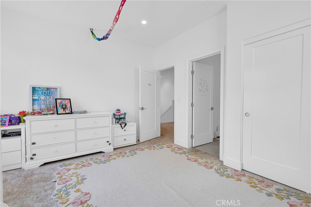 115 Halworth Irvine, CA 92618 - Photo 23 of 33 a room with a dresser and a chandelier