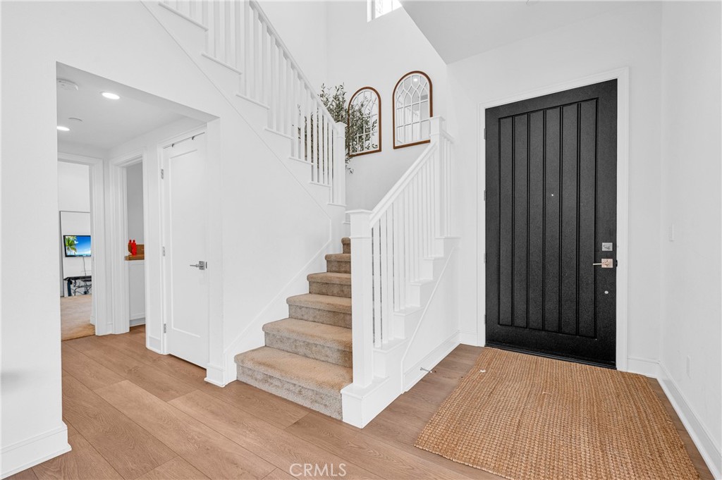 115 Halworth Irvine, CA 92618 - Photo 28 of 33 a view of a hallway with entryway wooden floor and front door