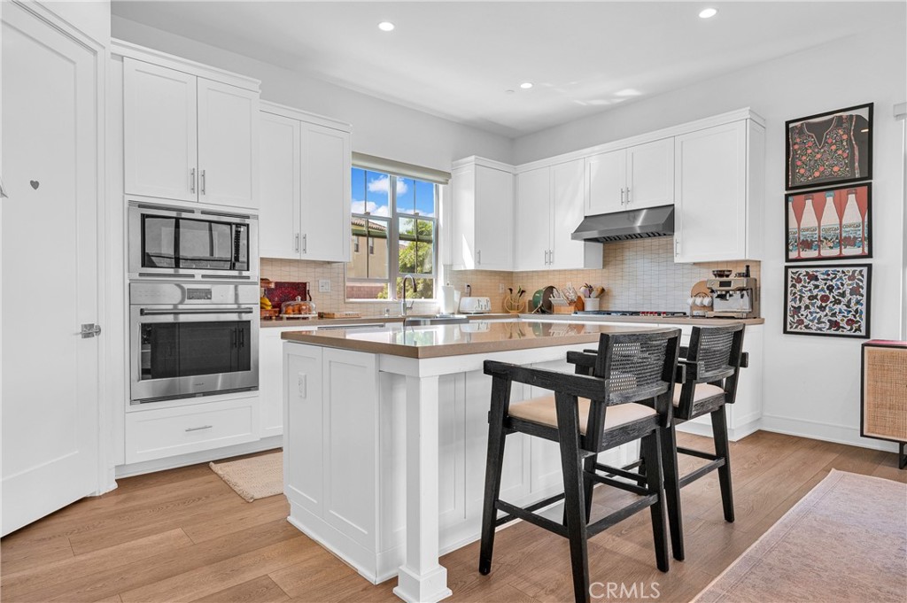 115 Halworth Irvine, CA 92618 - Photo 4 of 33 a kitchen with stainless steel appliances a stove a sink refrigerator and a microwave