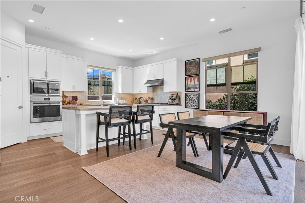 115 Halworth Irvine, CA 92618 - Photo 5 of 33 a room with stainless steel appliances kitchen island granite countertop a dining table chairs and granite counter tops