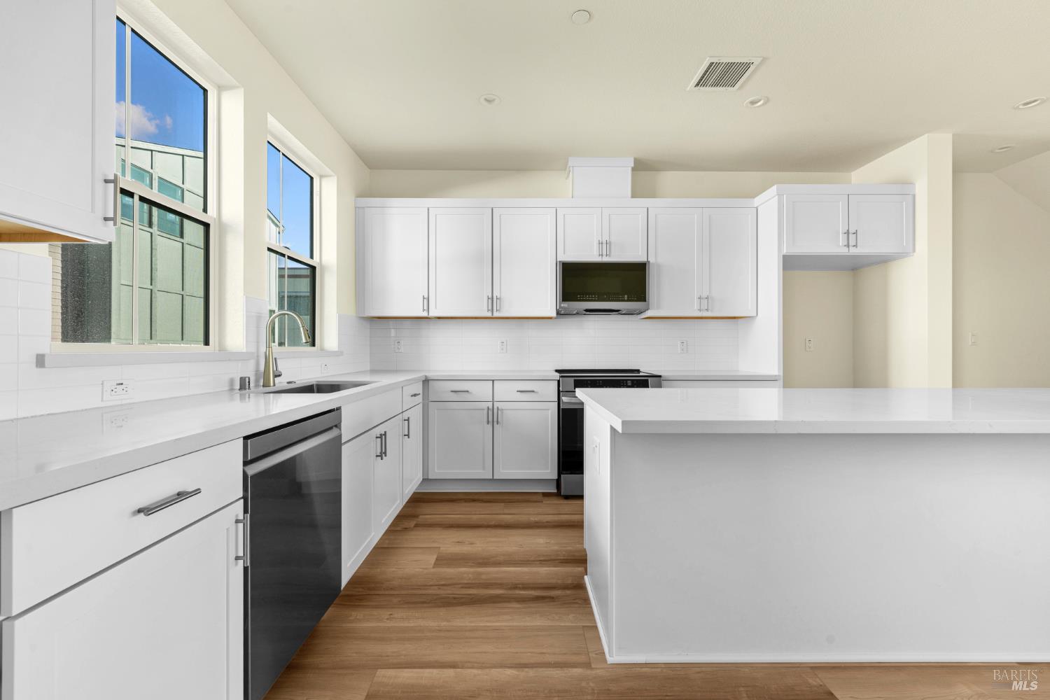 a kitchen with a sink stove and cabinets