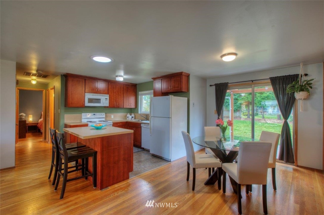 4209 Northeast 11th Street Renton, WA 98059 - Photo 2 of 17 a dining room with furniture window and wooden floor