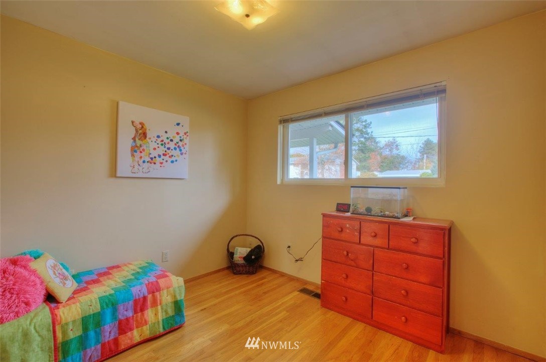 4209 Northeast 11th Street Renton, WA 98059 - Photo 12 of 17 a bedroom with a bed and a dresser in it