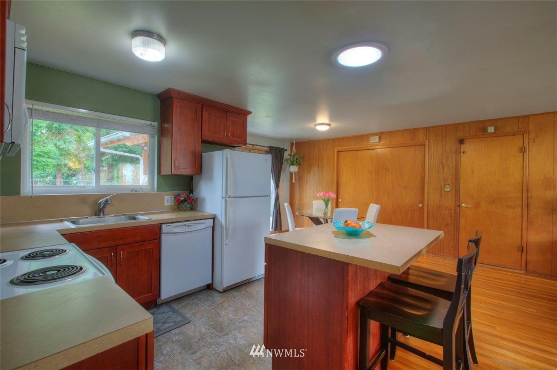 4209 Northeast 11th Street Renton, WA 98059 - Photo 4 of 17 a kitchen with refrigerator and table